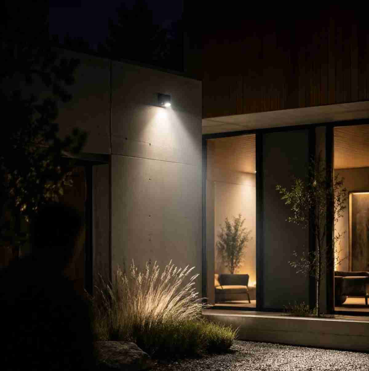 Aootek solar motion sensor lights installed along a dark pathway, casting warm illumination